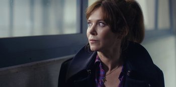 Movie still from “Marcella” (2016), created by Hans Rosenfeldt – A person sitting on a bench; Close Up shot, Over the shoulder angle