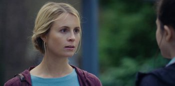 Movie still from “Marcella” (2016), created by Hans Rosenfeldt – A woman with blonde hair looking to her left; Close Up shot, Over the shoulder angle