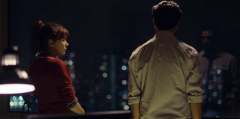 Movie still from “Marcella” (2016), created by Hans Rosenfeldt – A man and a woman standing next to each other in front of a city skyline at night; Medium shot, Over the shoulder angle