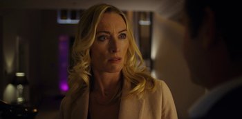 Movie still from “Marcella” (2016), created by Hans Rosenfeldt – A woman with blonde hair wearing a white jacket; Close Up shot, Over the shoulder angle