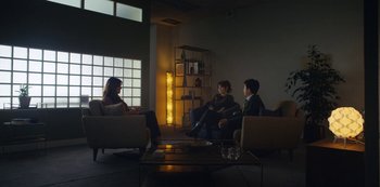 Movie still from “Marcella” (2016), created by Hans Rosenfeldt – A group of people sitting in a living room talking; Wide shot, Over the shoulder angle