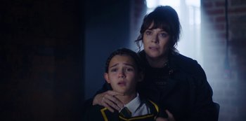 Movie still from “Marcella” (2016), created by Hans Rosenfeldt – A woman and a young boy in a dark room; Close Up shot, Over the shoulder angle