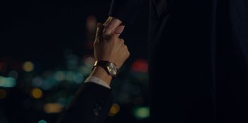 Movie still from “Marcella” (2016), created by Hans Rosenfeldt – Two people holding hands in front of a city skyline at night; Extreme Close Up shot, High angle