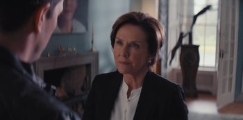 Movie still from “Marcella” (2016), created by Hans Rosenfeldt – A person wearing a suit and tie; Close Up shot, Over the shoulder angle