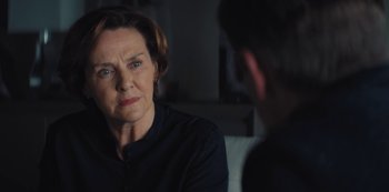 Movie still from “Marcella” (2016), created by Hans Rosenfeldt – An older woman sitting in front of a younger man; Close Up shot, Over the shoulder angle