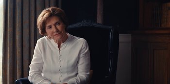 Movie still from “Marcella” (2016), created by Hans Rosenfeldt – A woman sitting in a chair in front of a black wall; Close Up shot, Over the shoulder angle