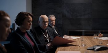 A group of people sitting at a wooden table