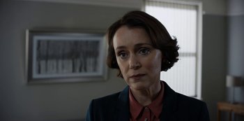 A woman in a red shirt and a black jacket