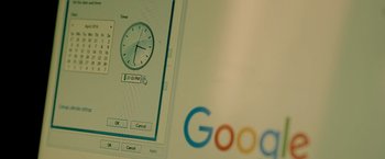 Movie still from “Mom” (2017), directed by Ravi Udyawar – The google logo with a clock on it; Extreme Close Up shot, High angle