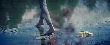 Movie still from “Mom” (2017), directed by Ravi Udyawar – A person walking across a body of water; Wide shot, Low angle