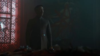 Movie still from “Game of Thrones” (2011), created by D.B. Weiss – A man standing in front of a painting in the dark; Medium shot, Low angle