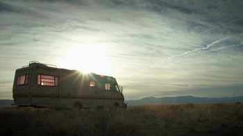 Movie still from “Breaking Bad” (2008), created by Vince Gilligan – An rv parked in the middle of a grassy field; Extreme Wide shot, Low angle