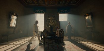 Movie still from “One Piece” (2023), directed by Marc Jobst – A group of people standing in a room with furniture; Wide shot, Low angle