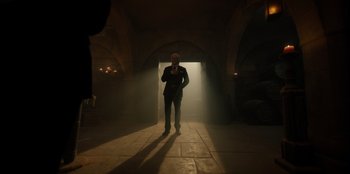 Movie still from “One Piece” (2023), directed by Marc Jobst – A man standing in the middle of an arched hallway; Wide shot, Low angle