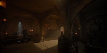 Movie still from “One Piece” (2023), directed by Marc Jobst – A room filled with lots of lights and a barrel; Extreme Wide shot, High angle