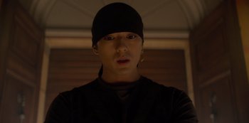 Movie still from “One Piece” (2023), directed by Marc Jobst – A young man wearing a black hat and a black shirt; Close Up shot, Low angle