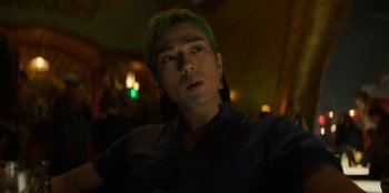 Movie still from “One Piece” (2023), directed by Marc Jobst – A man with green hair is taking a selfie; Close Up shot, Low angle