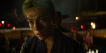 Movie still from “One Piece” (2023), directed by Marc Jobst – A person with green hair; Close Up shot, Over the shoulder angle