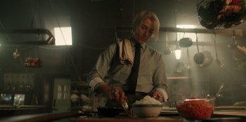 Movie still from “One Piece” (2023), directed by Marc Jobst – A man in a kitchen preparing a bowl of rice; Medium shot, Low angle