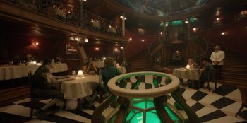 Movie still from “One Piece” (2023), directed by Marc Jobst – People are sitting at tables in a fancy restaurant; Wide shot, High angle