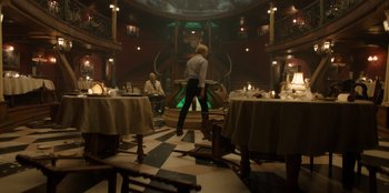 Movie still from “One Piece” (2023), directed by Marc Jobst – A man standing in front of tables in a restaurant; Wide shot, Low angle