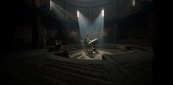 Movie still from “One Piece” (2023), directed by Marc Jobst – A person sitting at a desk in a dark room; Extreme Wide shot, High angle