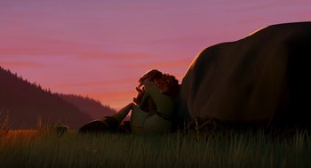 Movie still from “Open Season” (2006), directed by Roger Allers – A woman sitting in the grass next to an animal; Wide shot, Low angle