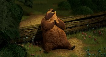 Movie still from “Open Season” (2006), directed by Roger Allers – A brown bear sitting on the ground next to a fallen tree; Wide shot, High angle