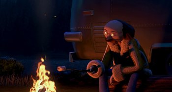 Movie still from “Open Season” (2006), directed by Roger Allers – An animated character sitting in front of a fire; Wide shot, High angle