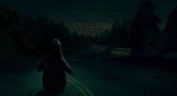 Movie still from “Open Season” (2006), directed by Roger Allers – A bear sitting on the side of a road at night; Extreme Wide shot, Low angle