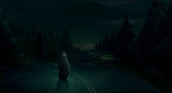 Movie still from “Open Season” (2006), directed by Roger Allers – A bear sitting in the middle of the road at night; Extreme Wide shot, High angle