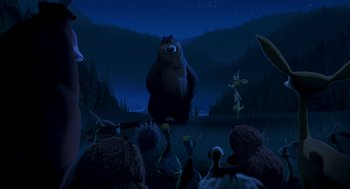 Movie still from “Open Season” (2006), directed by Roger Allers – A group of people gathered around a bear in a field; Extreme Wide shot, Low angle