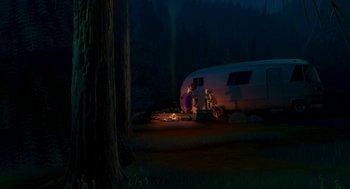 Movie still from “Open Season” (2006), directed by Roger Allers – Two people sitting on the ground next to an rv at night; Extreme Wide shot, High angle