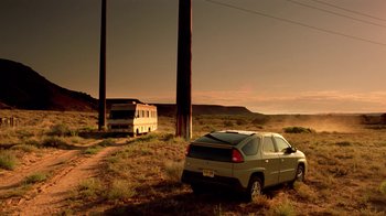 Movie still from “Breaking Bad” (2008), created by Vince Gilligan – An rv is parked in the middle of the desert near a car; Extreme Wide shot, Low angle