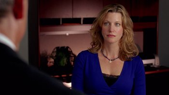 Movie still from “Breaking Bad” (2008), created by Vince Gilligan – A woman in a blue shirt is looking at the camera; Close Up shot, Over the shoulder angle