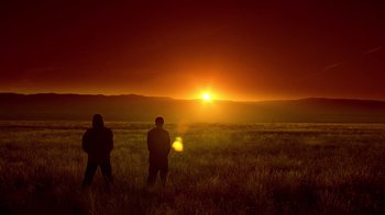 Movie still from “Breaking Bad” (2008), created by Vince Gilligan – Two people standing in a field watching the sun go down; Extreme Wide shot, Low angle