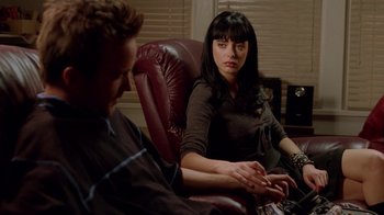 Movie still from “Breaking Bad” (2008), created by Vince Gilligan – A man and a woman sitting in a chair; Medium shot, High angle