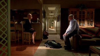Movie still from “Breaking Bad” (2008), created by Vince Gilligan – A man and a woman sitting in a hallway; Wide shot, High angle
