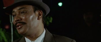 Movie still from “Paan Singh Tomar” (2012), directed by Tigmanshu Dhulia – A person wearing a suit and a hat; Close Up shot, Low angle
