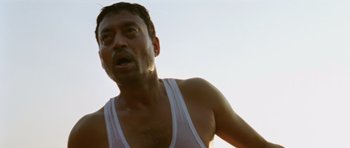 Movie still from “Paan Singh Tomar” (2012), directed by Tigmanshu Dhulia – A person wearing a white shirt; Close Up shot, Low angle