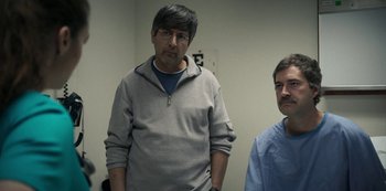 Movie still from “Paddleton” (2019), directed by Alex Lehmann – Two men standing next to each other in front of a wall; Medium shot, Over the shoulder angle