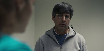 Movie still from “Paddleton” (2019), directed by Alex Lehmann – A man wearing glasses looking at a mirror; Close Up shot, Over the shoulder angle