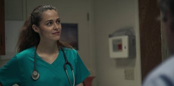 Movie still from “Paddleton” (2019), directed by Alex Lehmann – A woman in a green lab coat with a stethoscope around her neck; Close Up shot, Low angle