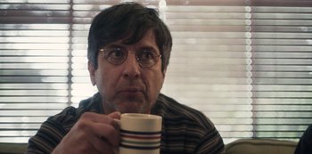 Movie still from “Paddleton” (2019), directed by Alex Lehmann – A man with glasses is holding a coffee mug; Close Up shot, Over the shoulder angle