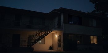 Movie still from “Paddleton” (2019), directed by Alex Lehmann – A building with a staircase going up the side of the building; Extreme Wide shot, Low angle