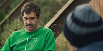 Movie still from “Paddleton” (2019), directed by Alex Lehmann – A man in a green sweatshirt is talking to another man; Close Up shot, Over the shoulder angle