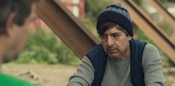 Movie still from “Paddleton” (2019), directed by Alex Lehmann – A man wearing glasses and wearing a hat; Close Up shot, Over the shoulder angle