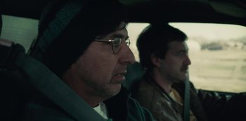 Movie still from “Paddleton” (2019), directed by Alex Lehmann – A man with glasses is sitting next to another man in a car; Close Up shot, Low angle