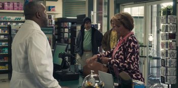 Movie still from “Paddleton” (2019), directed by Alex Lehmann – A group of people standing in a room; Medium shot, Over the shoulder angle