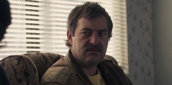 Movie still from “Paddleton” (2019), directed by Alex Lehmann – A person wearing a jacket; Close Up shot, Over the shoulder angle